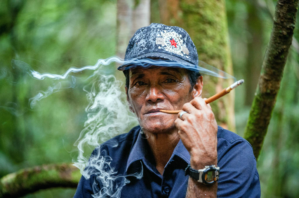 Camp Leaki, Borneo Island, Indonesia - May 4, 2008: The Indonesian guide, smokes a cigaret.