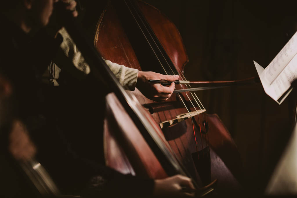 Hand of a cellist with playing classical music at the concert