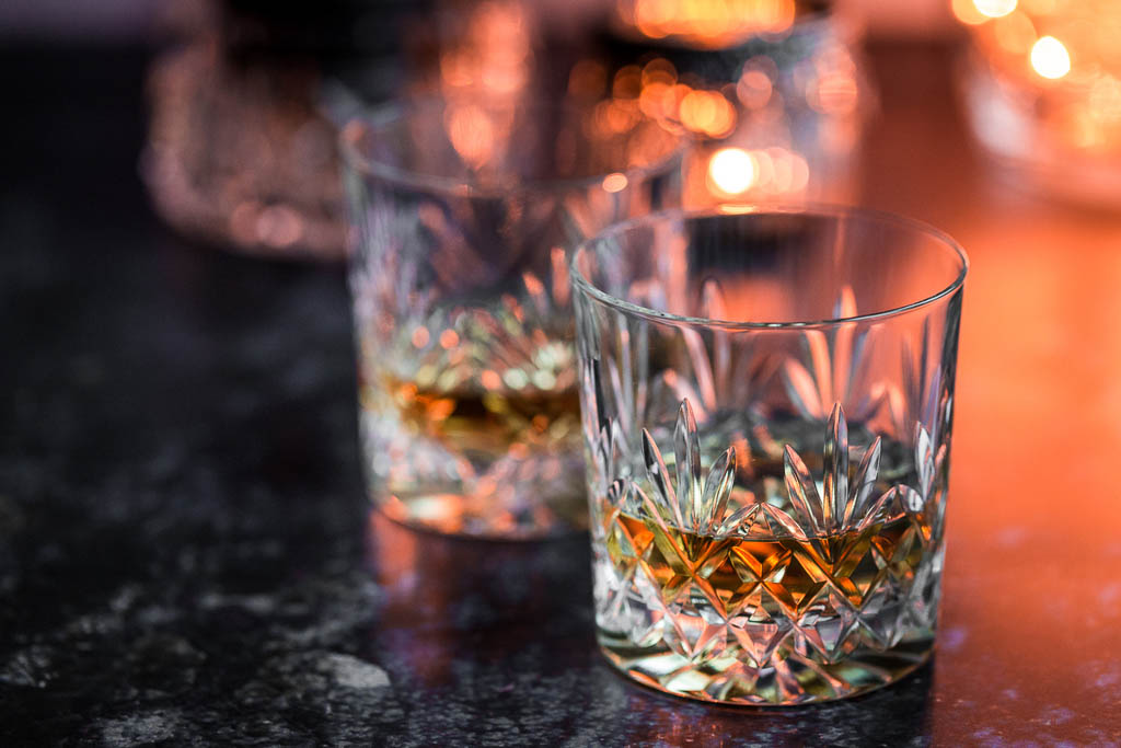 Crystal glasses of whisky on weathered surface