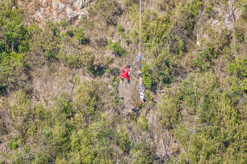 Bloukrans Bridge, South Africa March 2, 2016: An official preparing to hoist an unidentified bungee jumper back to the bridge after the worlds highest commercial bungee jump at the Bloukrans Bridge