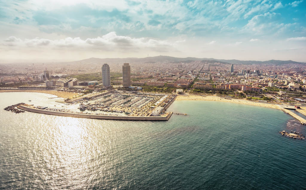 Barcelona skyline aerial view with skyscrapers by the beach, Spain. Vintage colors