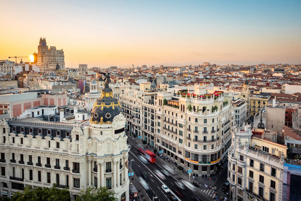 Sunset over Madrid showing Gran Via street at landmark buildings in Central Madrid, the capital and largest city in Spain.