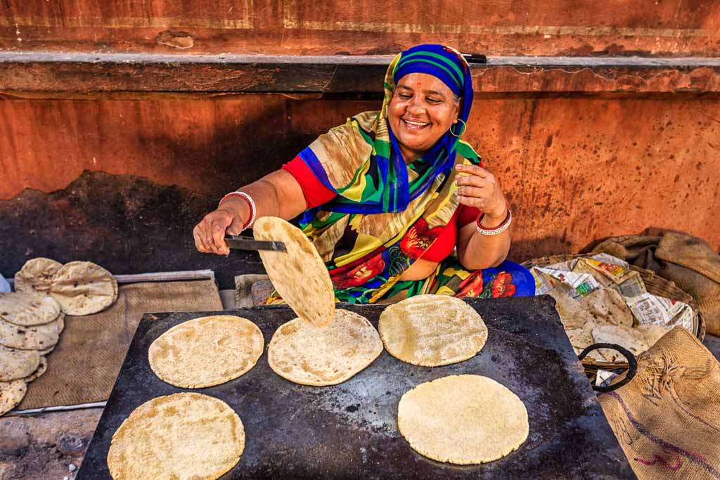 Indian street vendor preparing food - chapatti, flat bread, Jaipur - The Pink City, Rajasthan, India. Jaipur is known as the Pink City, because of the color of the stone exclusively used for the construction of all the structures.