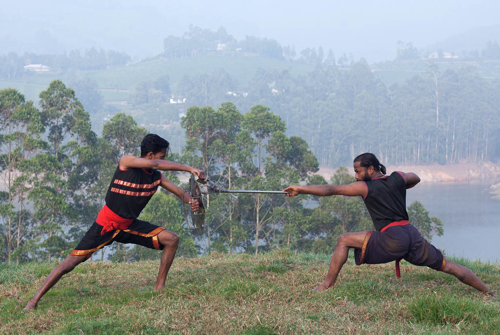 Indian fighters performing Aayudha Payattu (Weapon Combat) during Kalaripayattu Marital art demonstration in Kerala, South India
