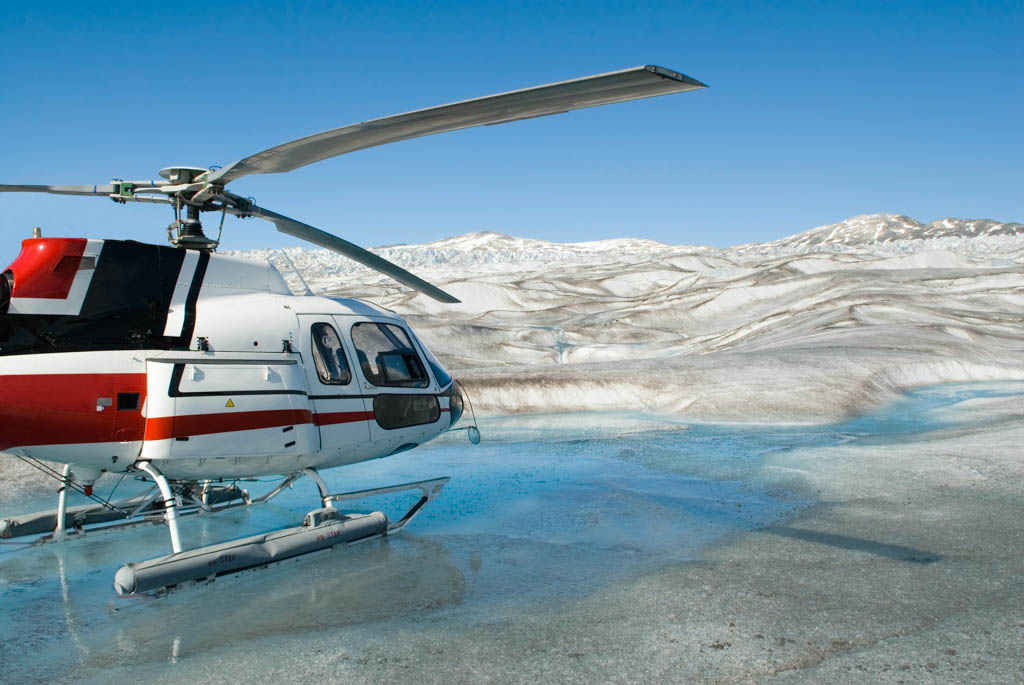 Helicopter landed on the smooth blue icy surface of a glacier in Alaska.Click on any of the sample images below to view a lightbox of all of my snow and glaciers shots: