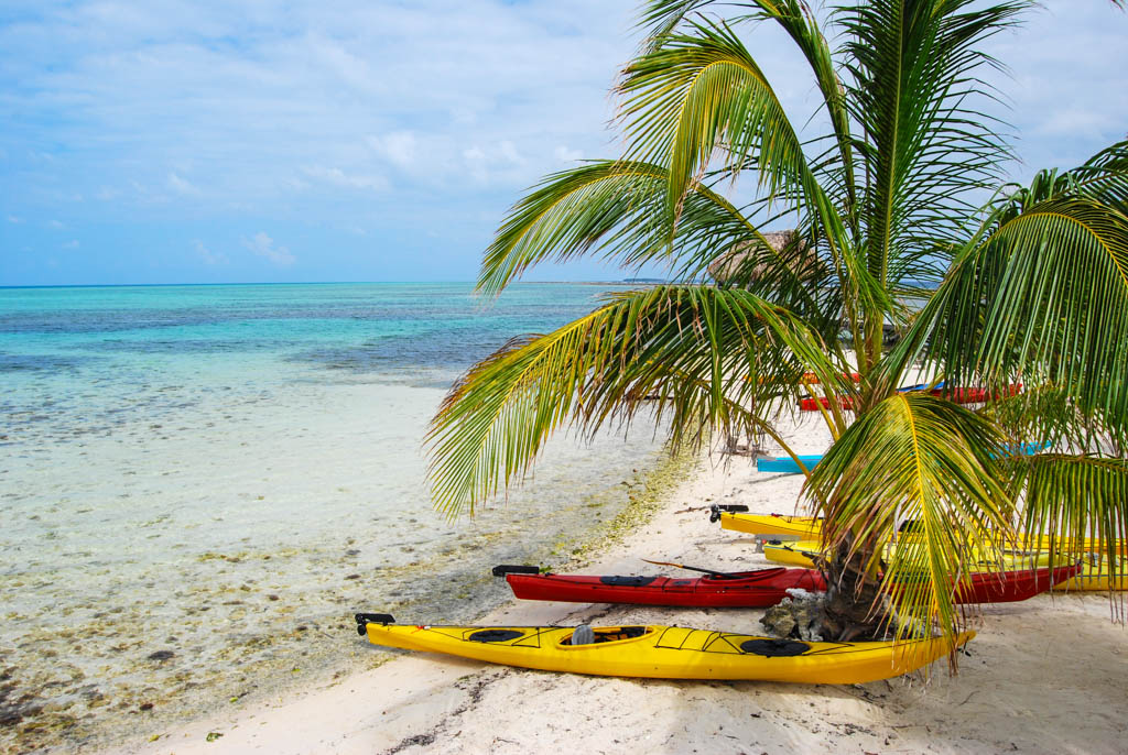 Kayaks on the beach at Glover's Atoll, Belize.