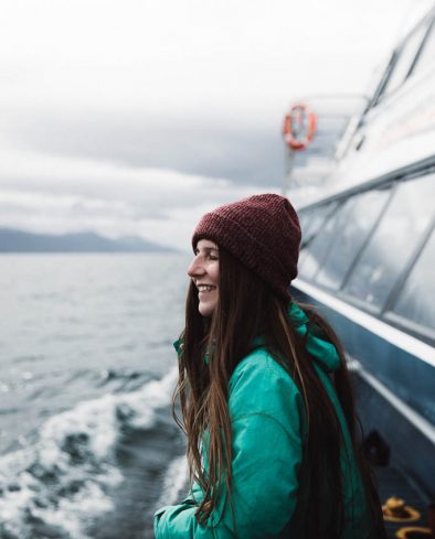 Woman looking at ocean from the ship in Ushuaia