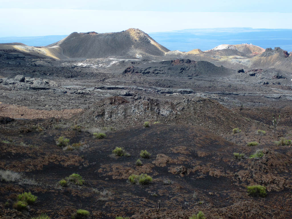 A cinder cone is visible in the volcanic landscape on the side of the Sierra Negra volcano on Isabel Island in the Galapagos.