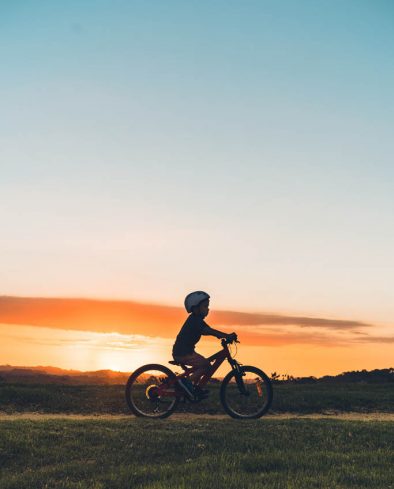 Kid enjoying outdoor on his bike during sunset in Auckland, New Zealand.