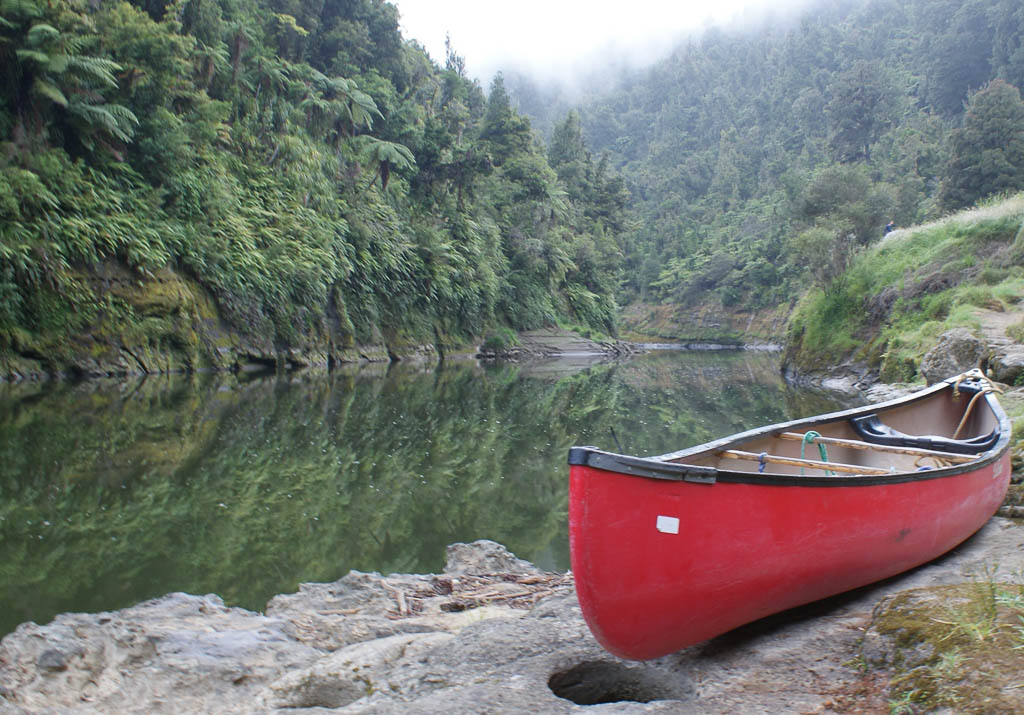 an early morning photo of a canoe on the bank of the Whanganui river