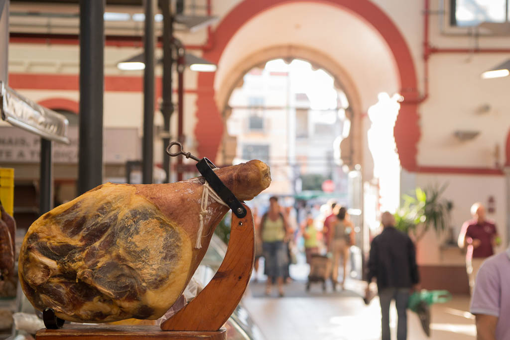 Ham in the Markethall in the town of Loule in the Algarve in the south of Portugal in Europe.