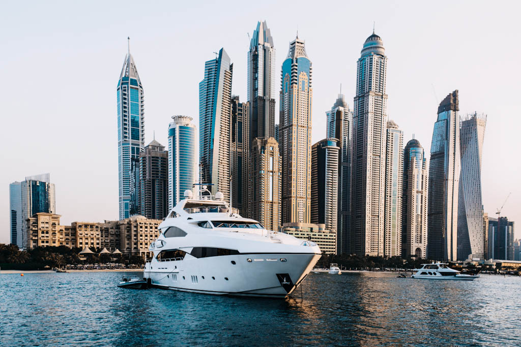 The yacht against the background of skyscrapers floats, Dubai