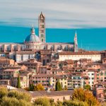 Beautiful view of Dome and campanile of Siena Cathedral, Duomo di Siena, and Old Town of medieval city of Siena in the sunny day, Tuscany, Italy