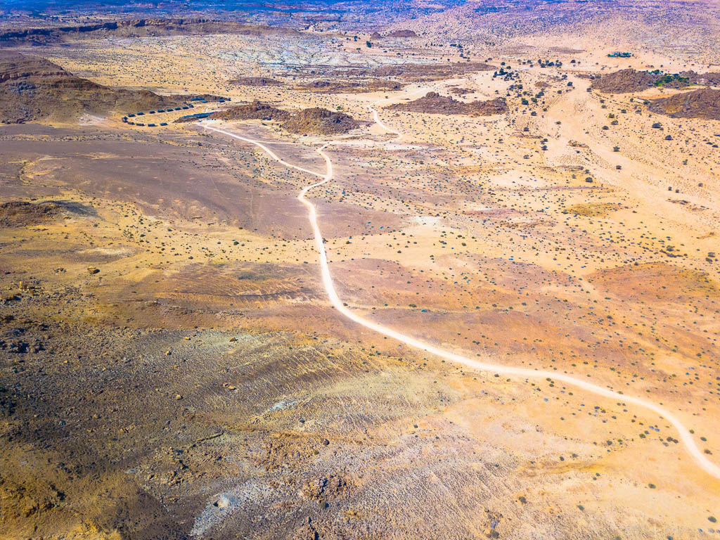 Aerial view: a gravel curvy road through the Fish River Canyon, Namibia