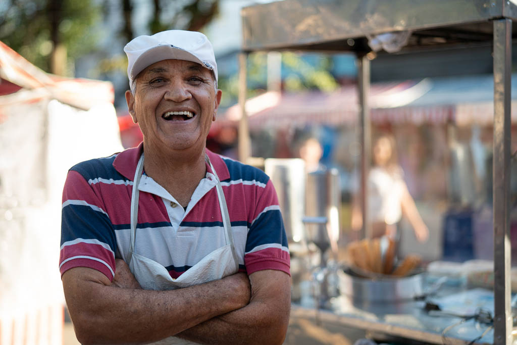 Mature Man selling churros at street portrait