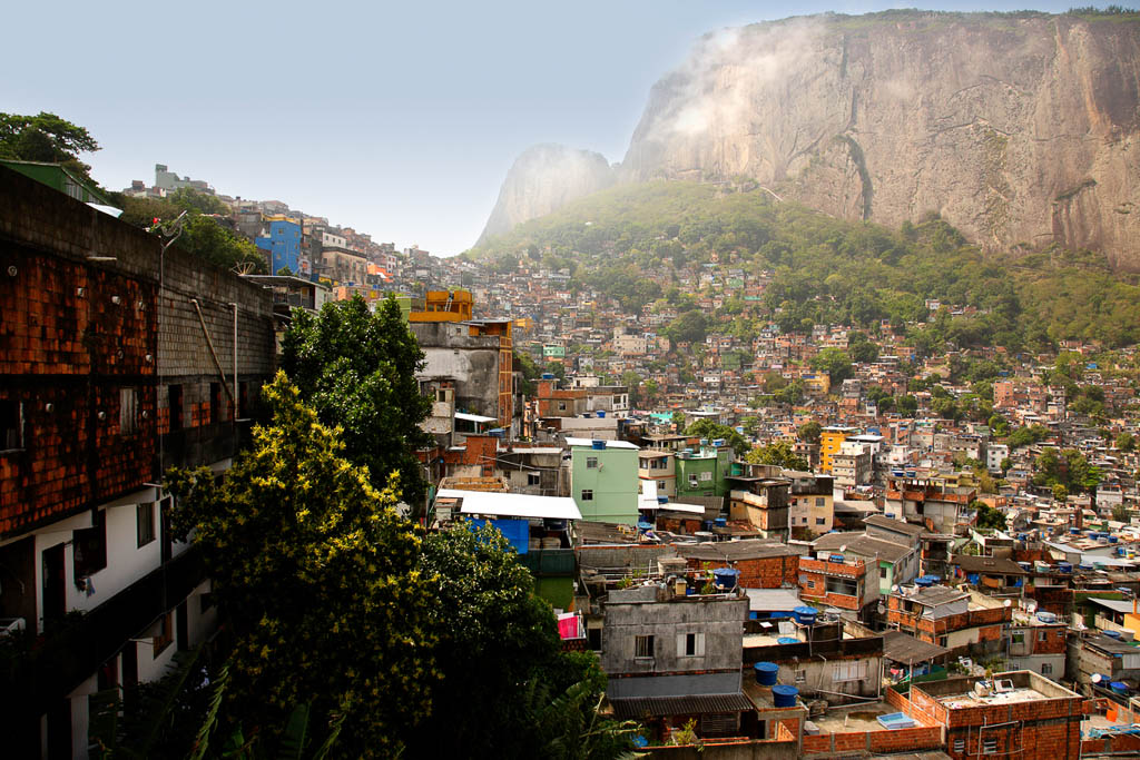 Photo taken from inside Rocinha favela in Rio de Janeiro. This favela is built on a steep hillside and is considered the largest in Brazil. It is fairly well developed, with decent sanitation, electricity and plumbing. This favela is slated to be pacified in time for the 2014 World Cup Soccer and 2016 Summer Olympics.See more favela photos in Urban scape lightbox below.