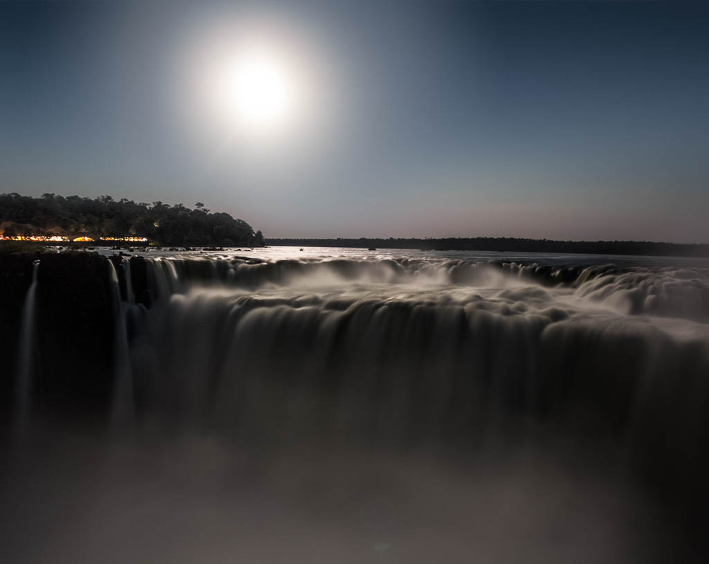 Iguazú falls at moonlight, from argentina side. Devil's Throat fall. You can see the lights of the Brazilian side