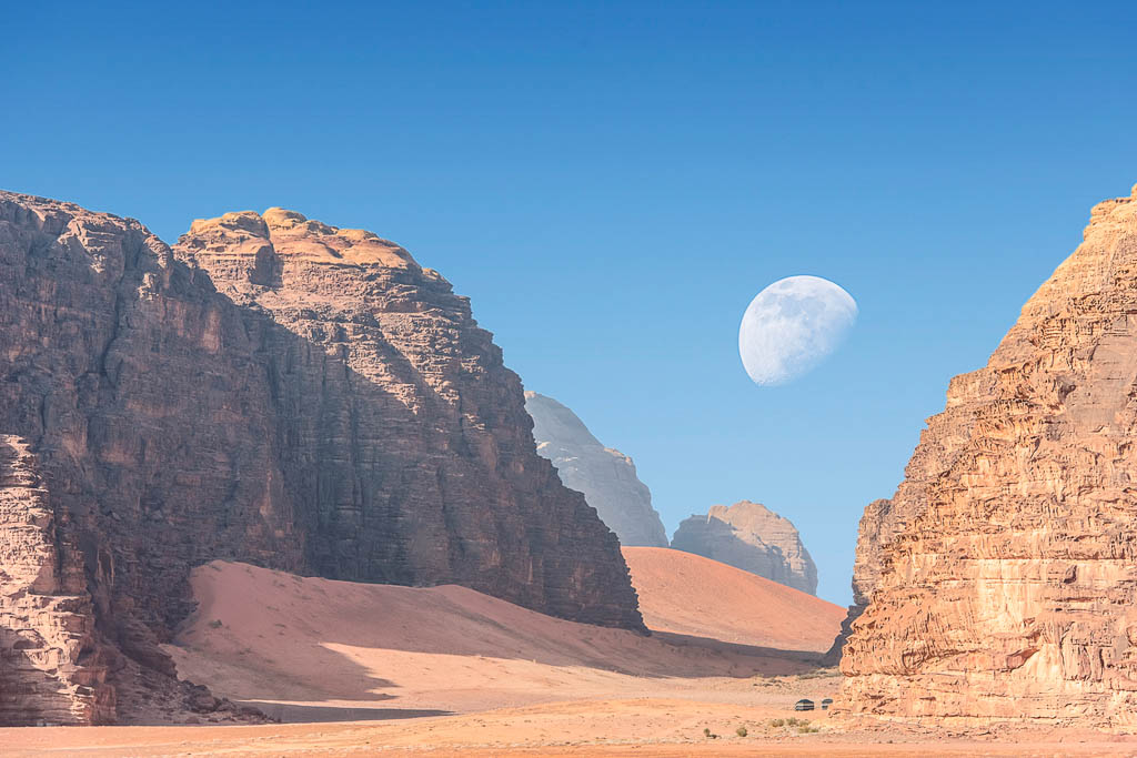 incredible lunar landscape with huge moon in Wadi Rum village in the Jordanian red sand desert. Wadi Rum also known as The Valley of the Moon, Jordan - Image