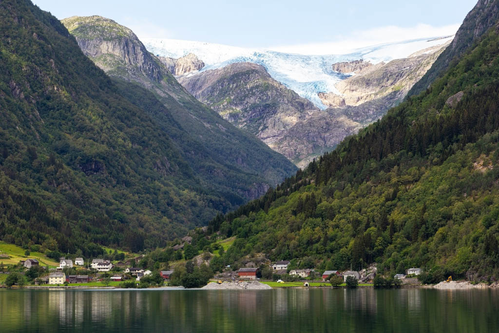 Summer morning in Norway, a village near the small town of Odda, on the river Opo. In the background you can see the glaciers of Folgefonna National Park.