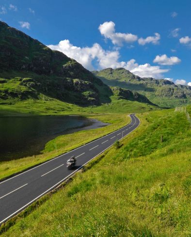 Speeding motorbike on mountain road in Scotland. Road A83 Argyll and Bute, Loch Restil