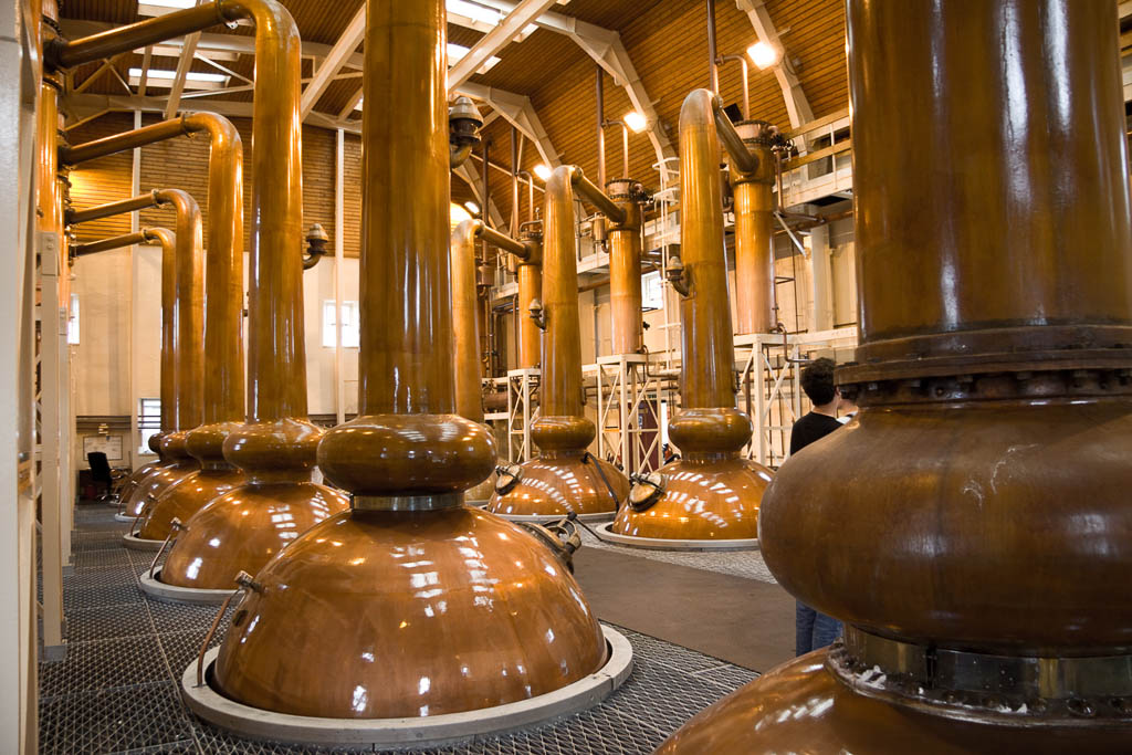 Large whiskey distills in a whiskey distilery in Scotland.