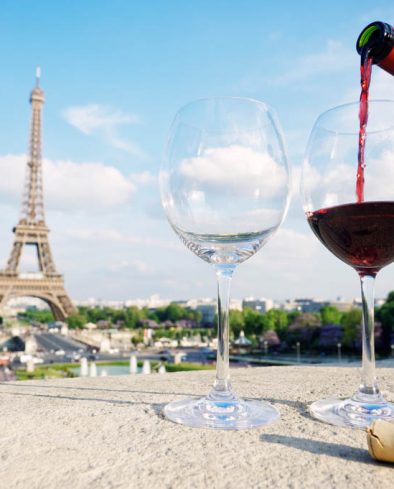 Two glasses and a fresh bottle of red wine overlooking the Eiffel Tower Paris