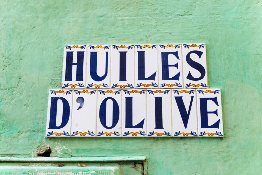 Olive oil sign, ceramic tiles on green wall, in Provence, France, Europe.