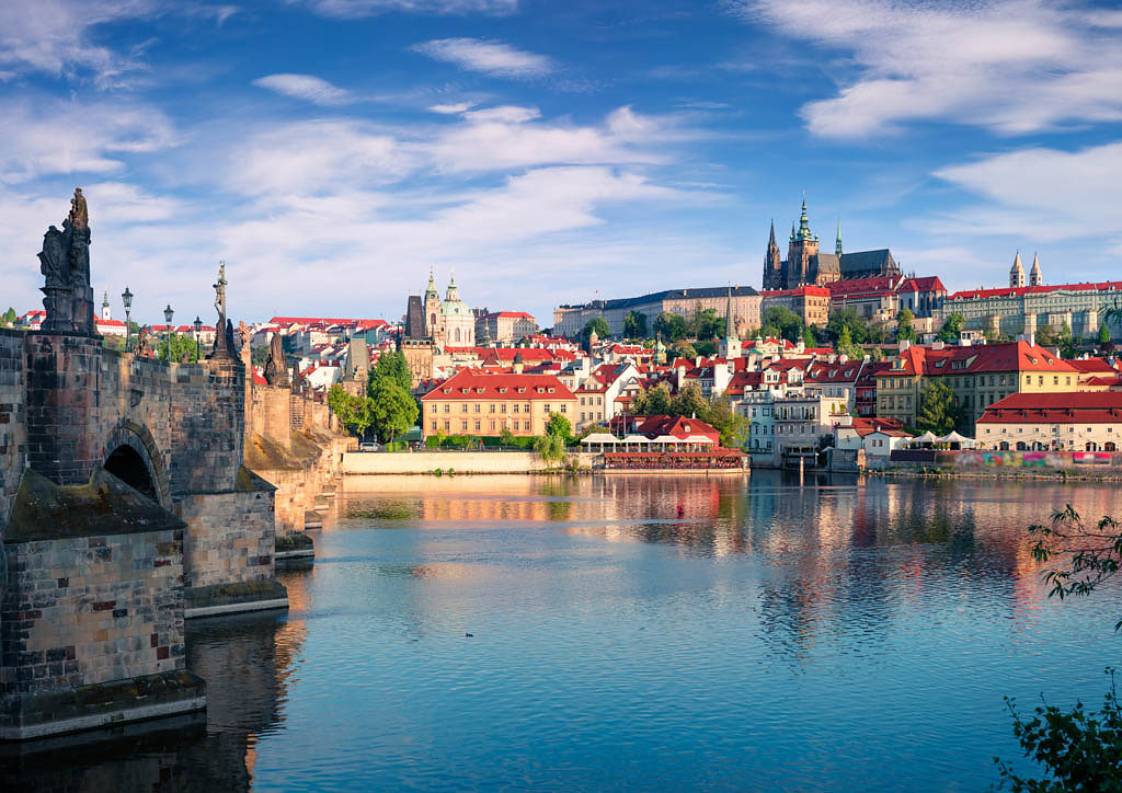 Colorful morning view of Charles Bridge, Prague Castle and St. Vitus cathedral on Vltava river. Sunny spring scene in Prague, Czech Republic, Europe. Artistic style post processed photo.