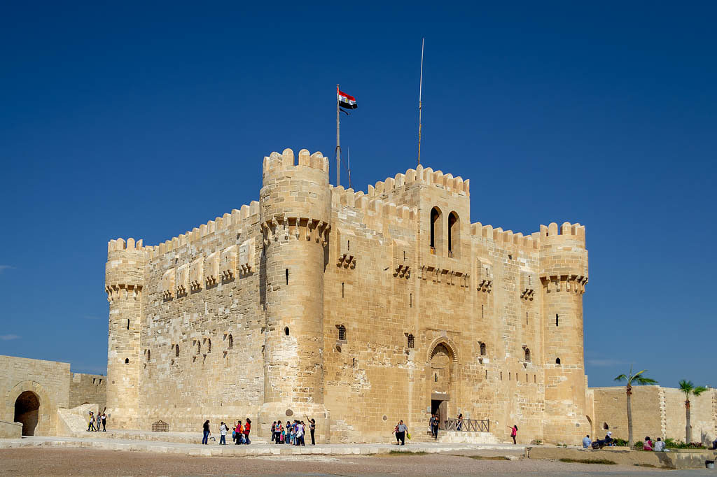 Alexandria, Egypt - October 25, 2012: Citadel of Qaitbay, a 15th century defensive fortress located on the Mediterranean sea coast, established in 1477 AD with local residents visiting the place